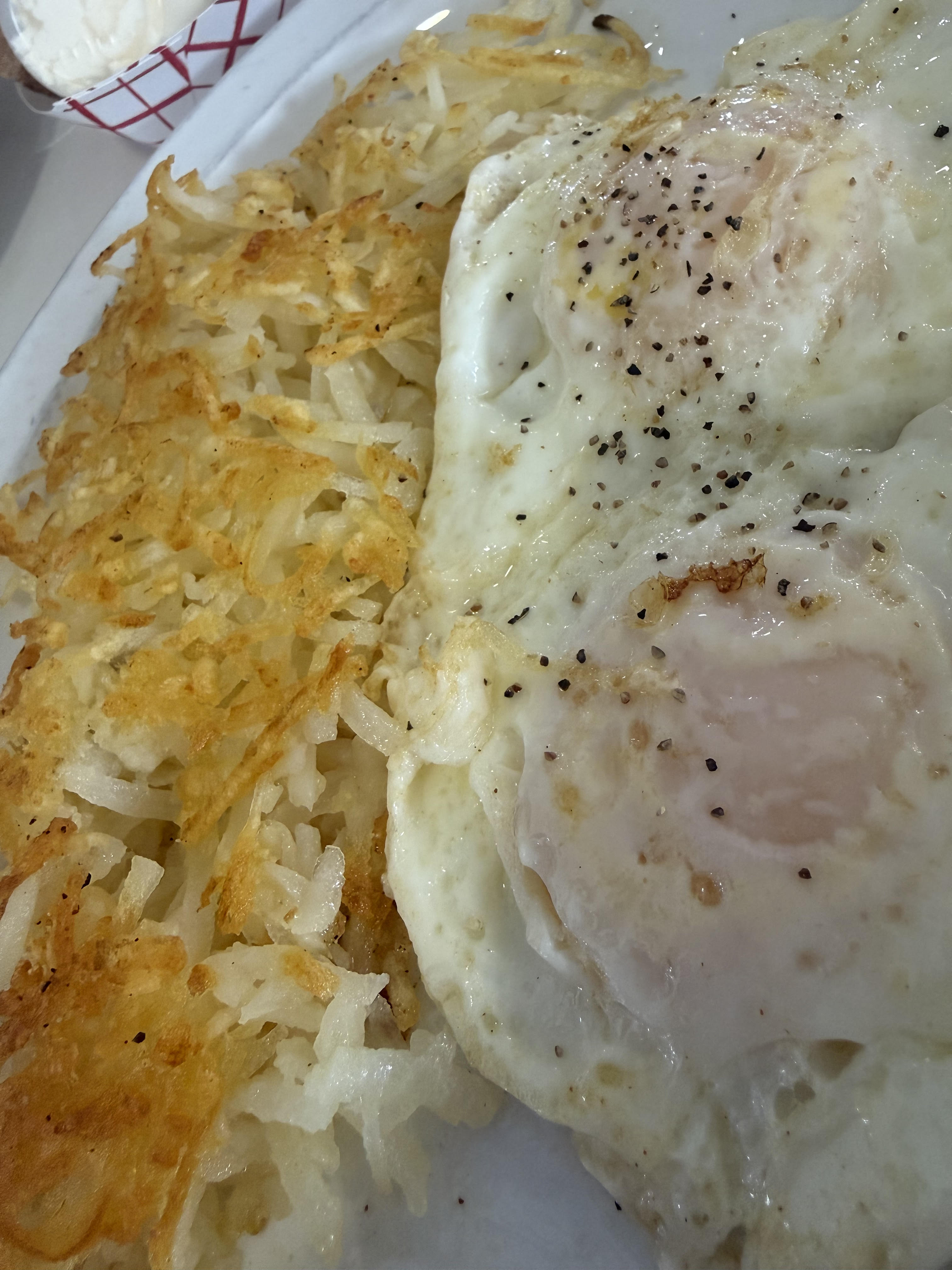 Classic breakfast plate with fried eggs and crispy hash browns